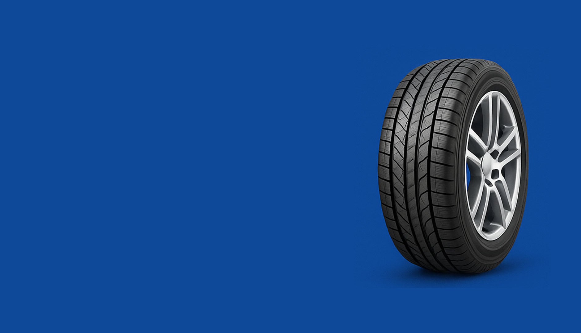 Car tire with alloy wheel on a blue background